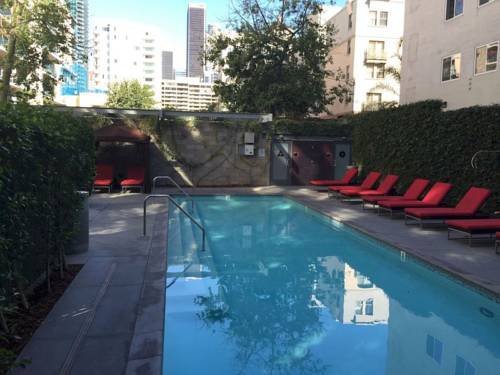 Downtown LA apartment building rooftop pool with city skyline views