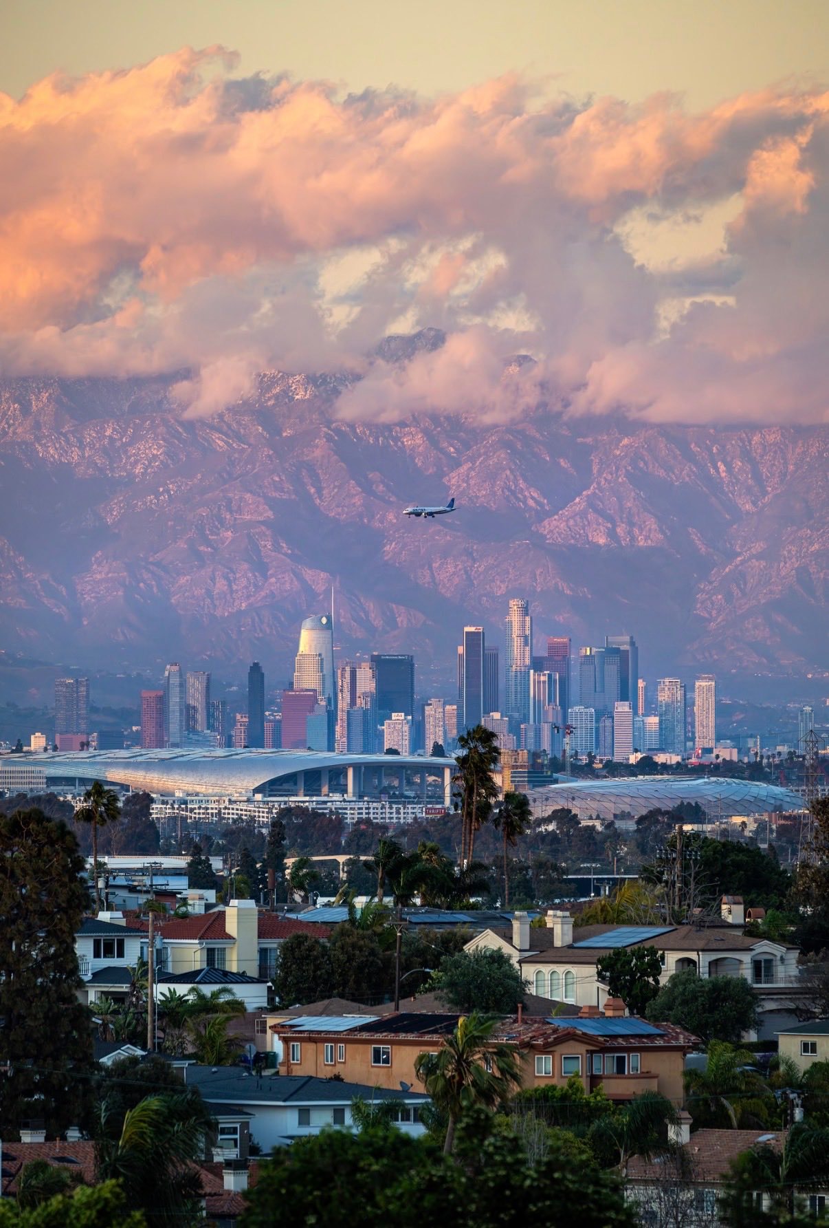 Los Angeles skyline with mountains and pink sunset clouds
