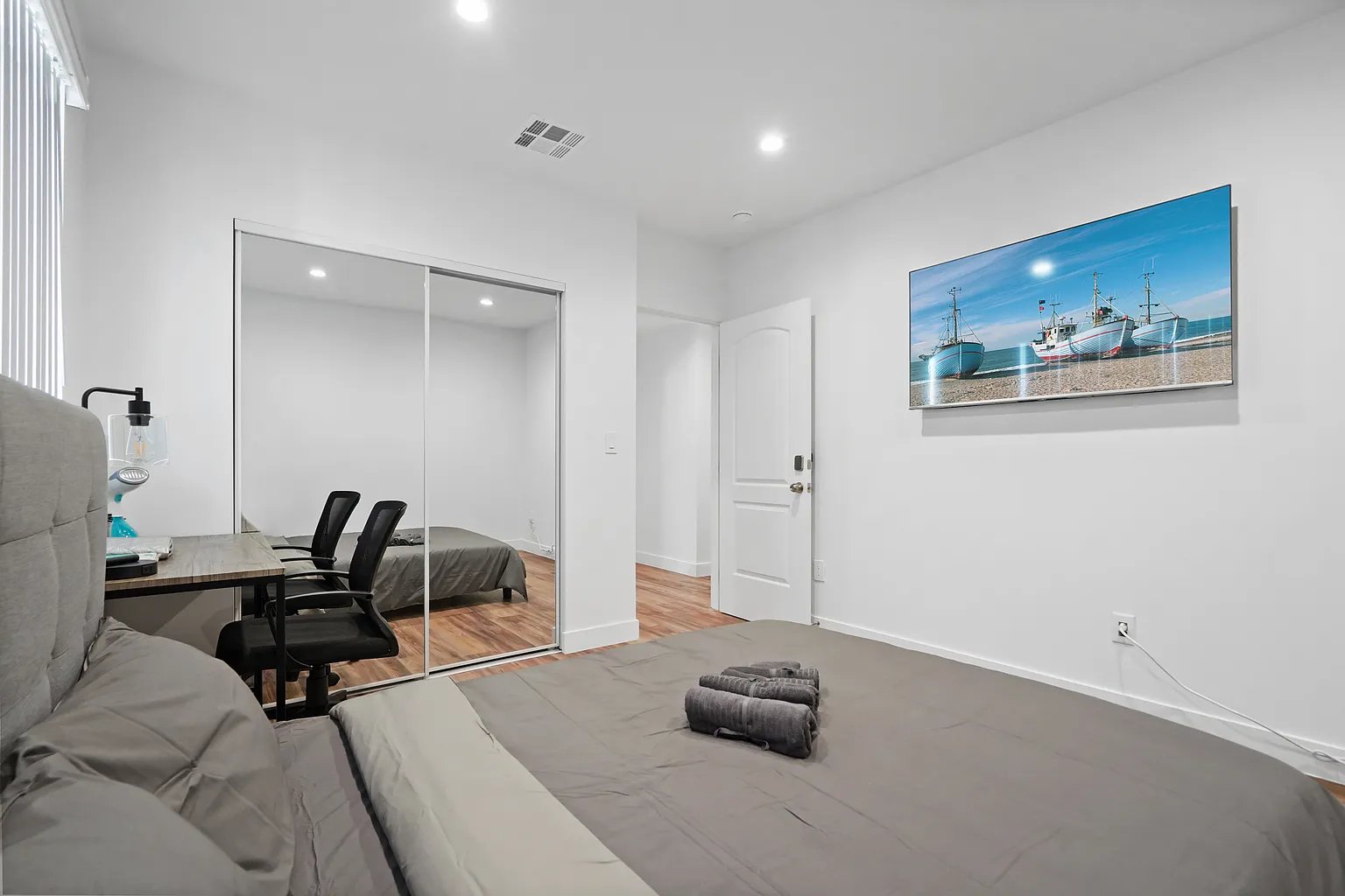 Culver City furnished apartment bedroom with queen bed, mirrored closet, and dedicated work desk