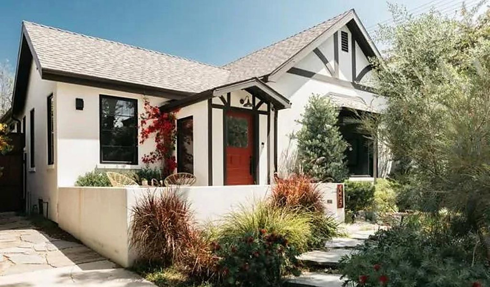 Furnished craftsman house exterior with Tudor details and landscaped garden in Santa Monica