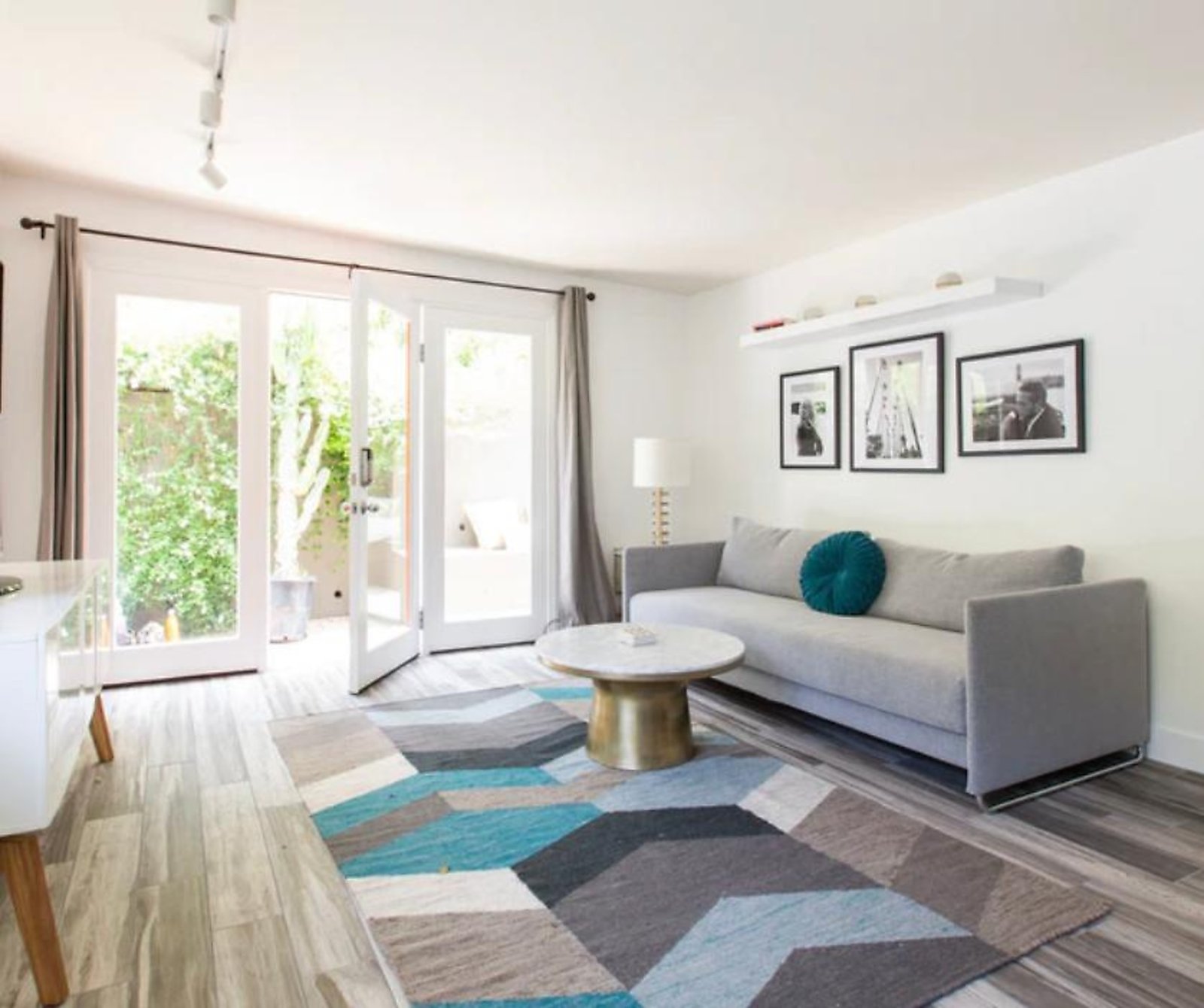 West Hollywood corporate housing living room with gallery wall and natural light