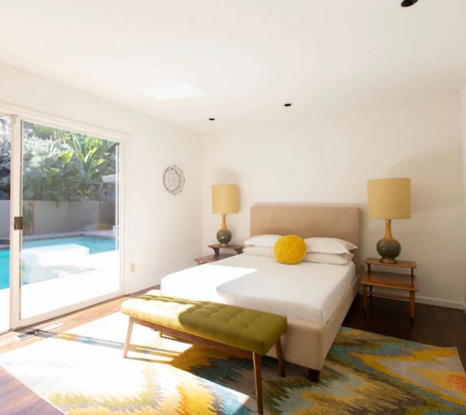 West Hollywood furnished apartment bedroom with private pool access and sliding glass doors
