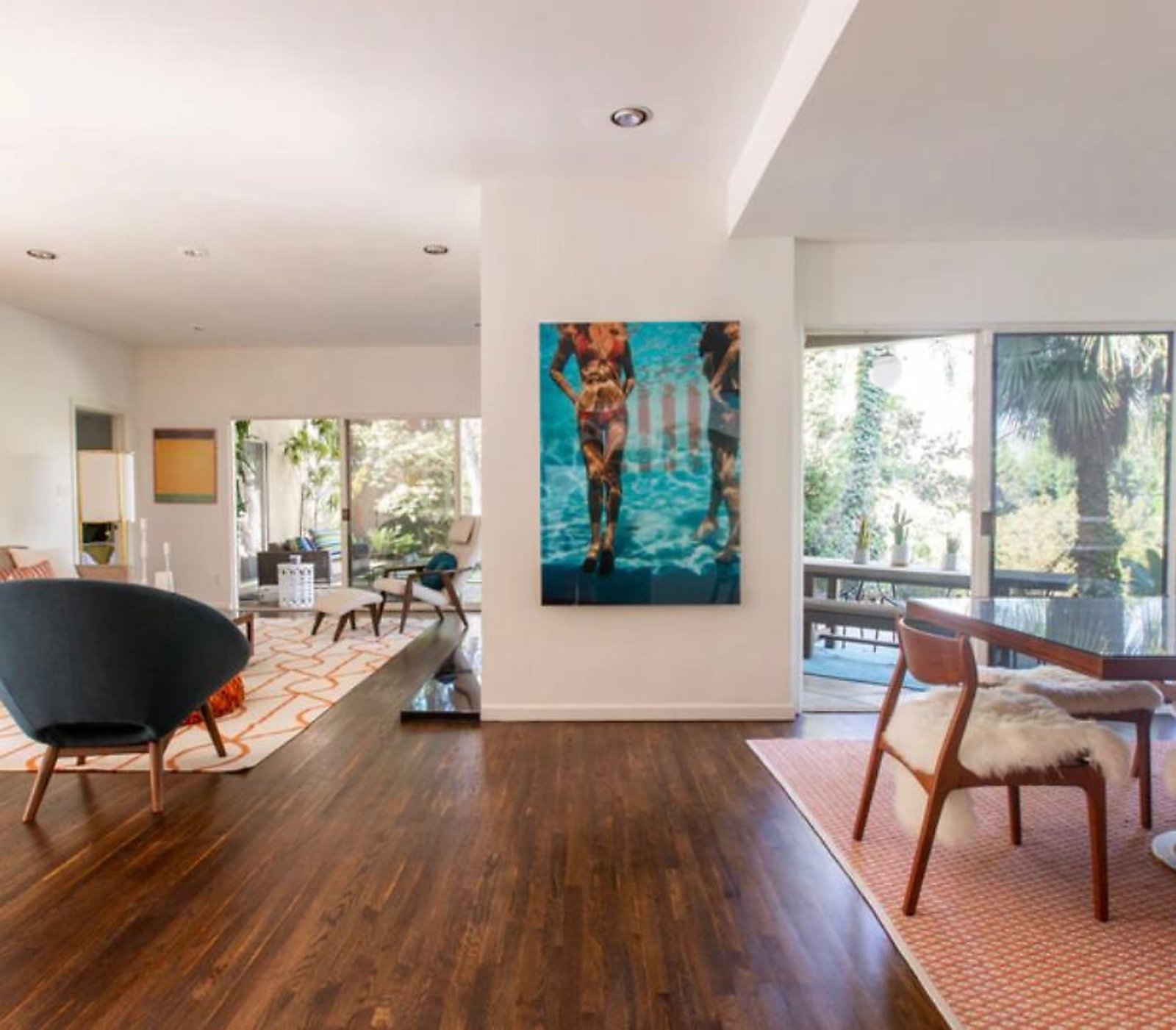 West Hollywood furnished apartment living room with statement art and hardwood floors