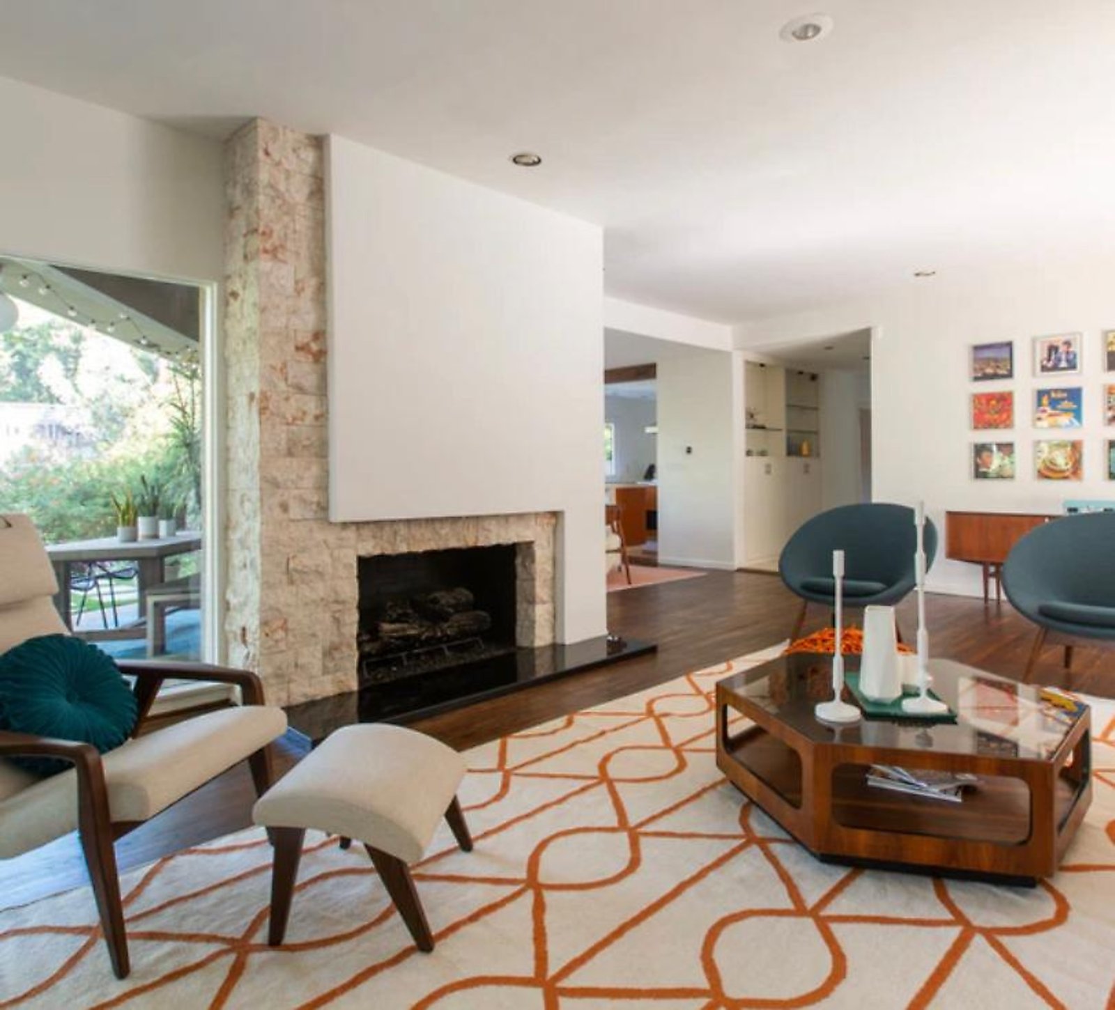 West Hollywood furnished apartment mid-century living room with stone fireplace and floor-to-ceiling windows near Sunset Strip
